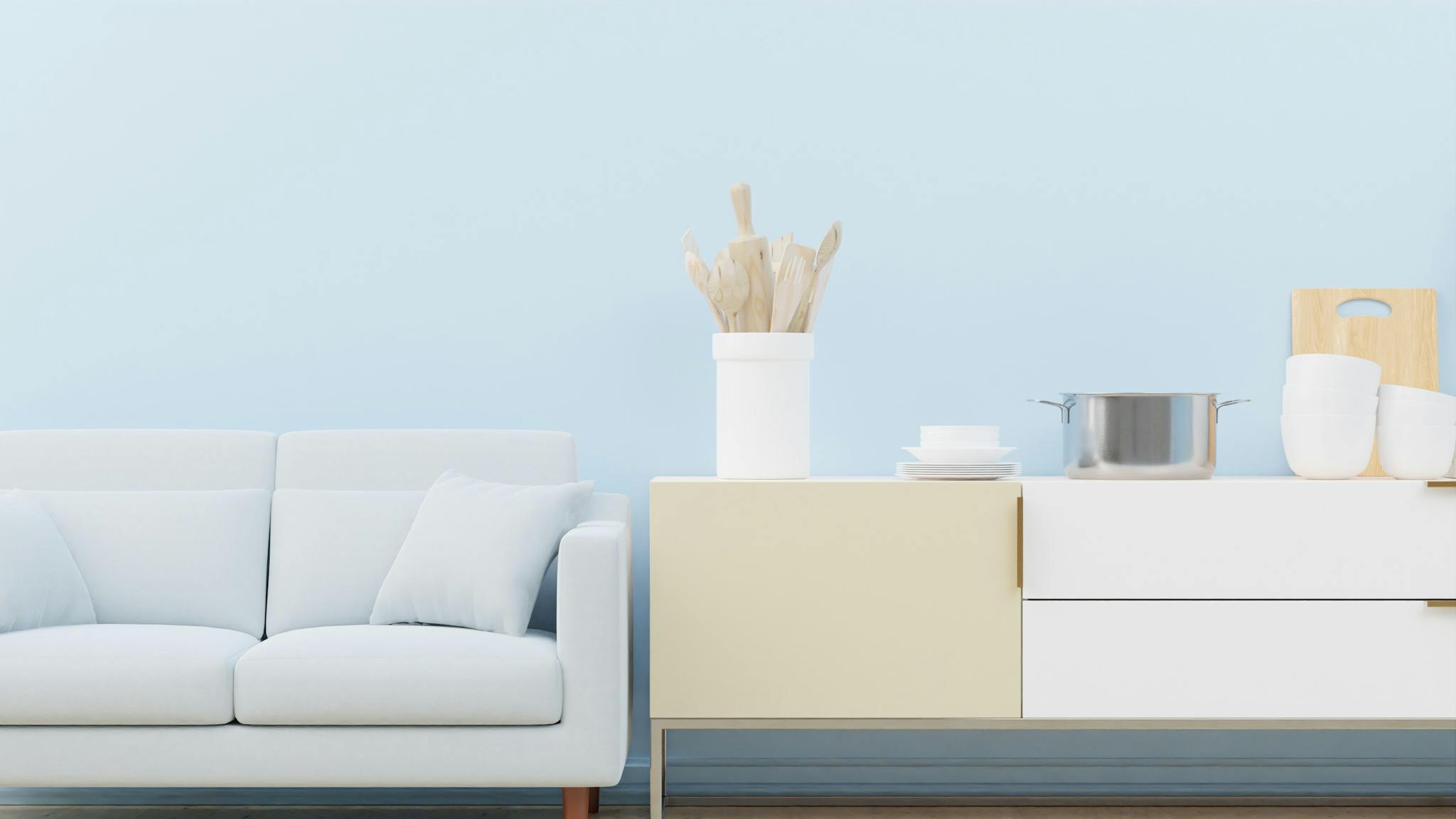 Stylish minimalist living room with a cozy sofa and elegant kitchen decor.
